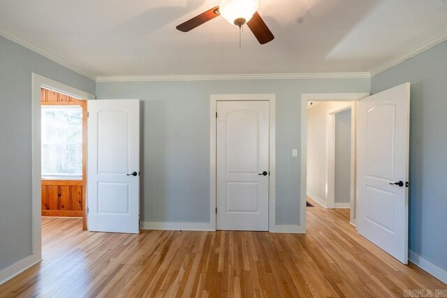 unfurnished bedroom featuring crown molding, baseboards, and light wood-type flooring