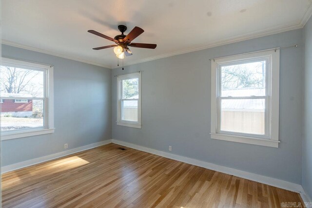 unfurnished room featuring light wood-style flooring, ceiling fan, baseboards, and ornamental molding