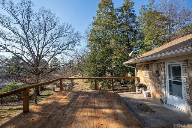 wooden terrace featuring a grill