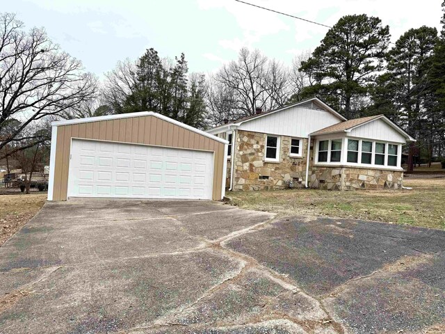 view of front facade featuring a garage and stone siding