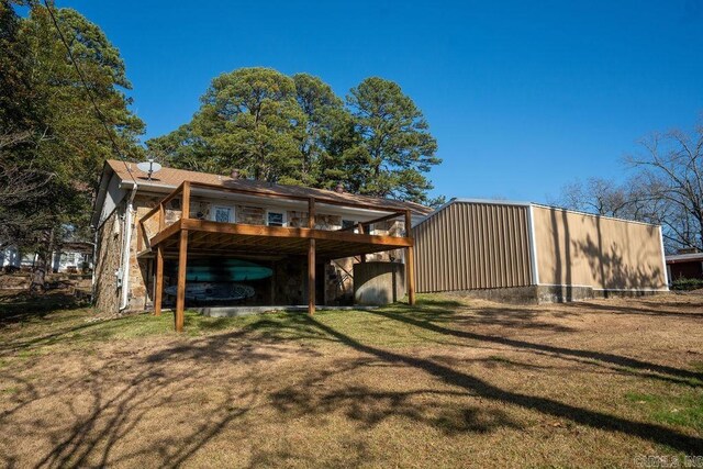 exterior space with a yard, a deck, and a carport