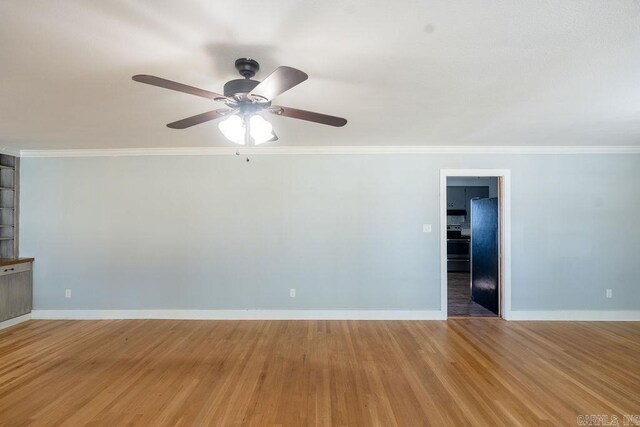 spare room with ceiling fan, baseboards, light wood-style floors, and ornamental molding