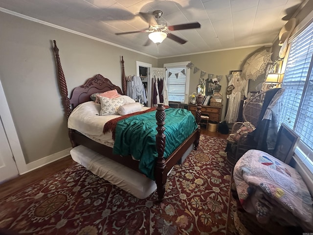 bedroom with ceiling fan, crown molding, wood-type flooring, and multiple windows