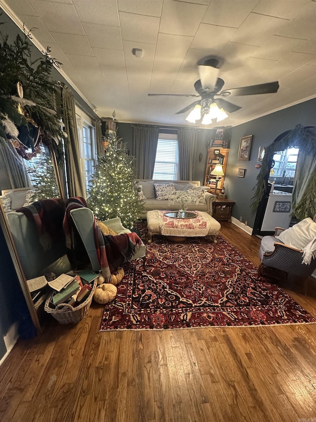 living room with ceiling fan, hardwood / wood-style floors, and crown molding