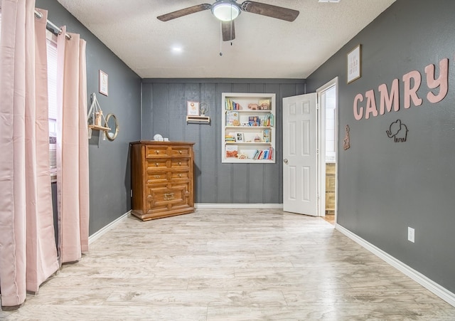 interior space featuring a textured ceiling, light hardwood / wood-style floors, and ceiling fan