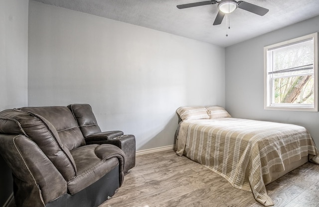 bedroom with ceiling fan and light hardwood / wood-style flooring