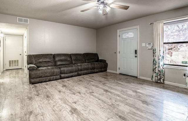 living room with ceiling fan and light hardwood / wood-style flooring