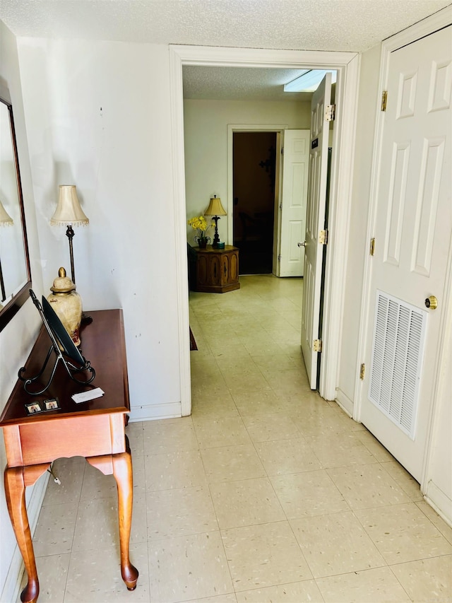 corridor with a textured ceiling