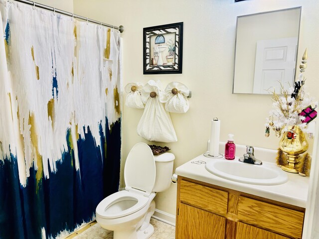 bathroom with tile patterned floors, vanity, and toilet