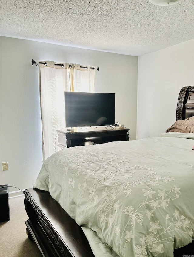 carpeted bedroom featuring a textured ceiling