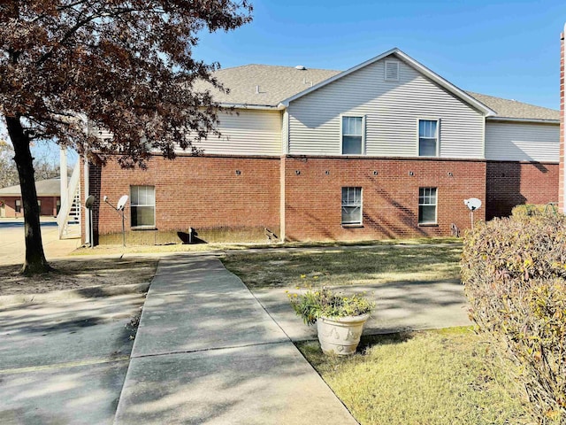 view of side of home with a lawn