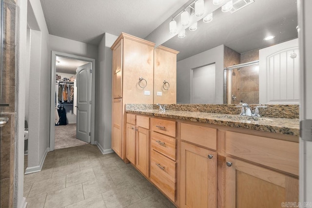 bathroom featuring vanity and walk in shower