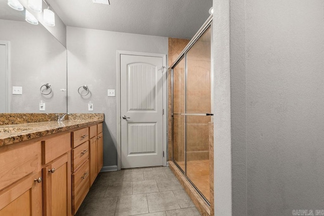 bathroom featuring vanity, tile patterned floors, and an enclosed shower