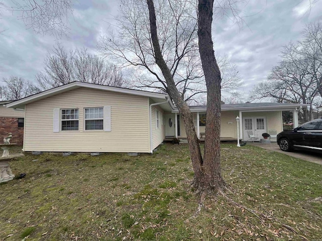 view of side of property with a yard