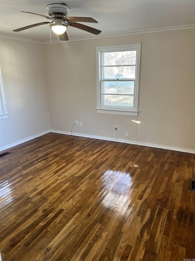 unfurnished room with ceiling fan, dark hardwood / wood-style flooring, and ornamental molding