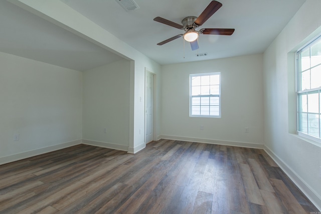 spare room with ceiling fan and dark wood-type flooring