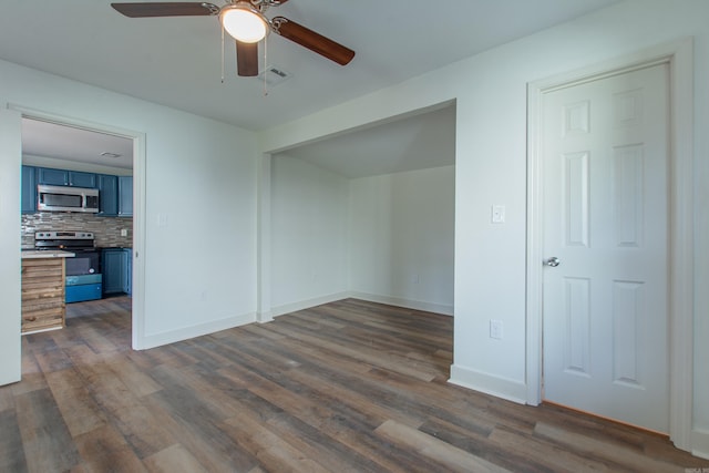 spare room featuring dark hardwood / wood-style flooring and ceiling fan