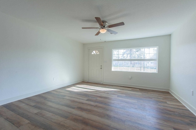 interior space with dark hardwood / wood-style floors and ceiling fan