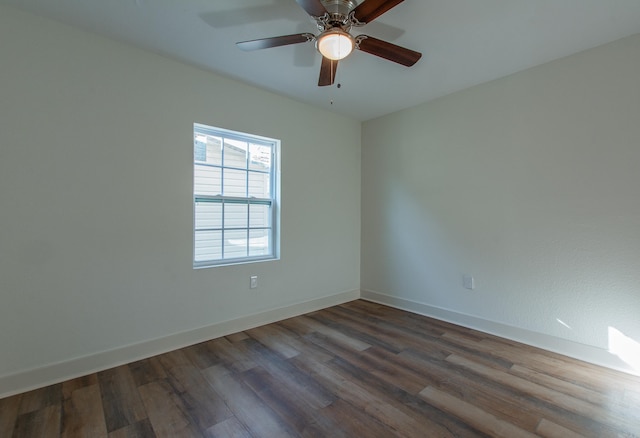 unfurnished room with ceiling fan and dark hardwood / wood-style flooring