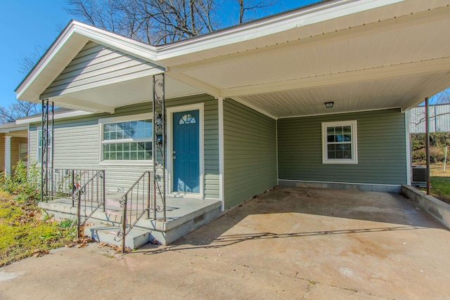 view of exterior entry with a carport