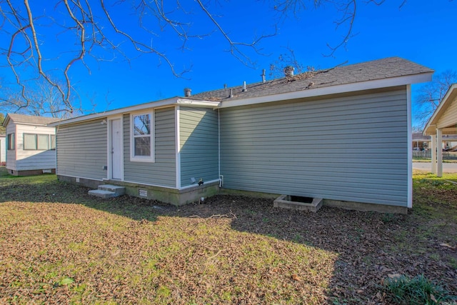 rear view of property featuring a yard