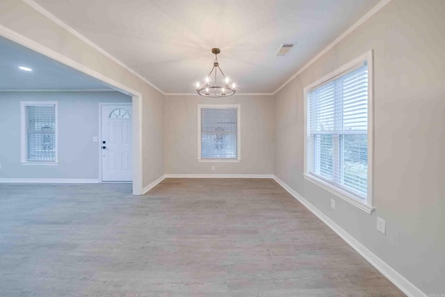 unfurnished dining area featuring light hardwood / wood-style floors, crown molding, and a notable chandelier