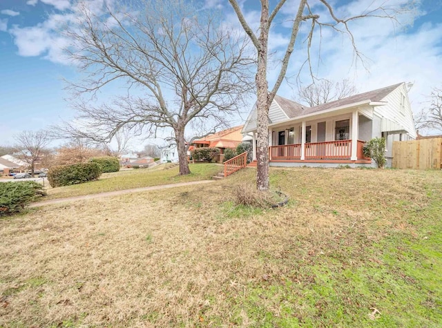 view of front of house with a front yard and covered porch