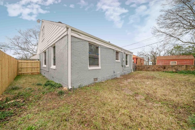 view of side of property with a yard