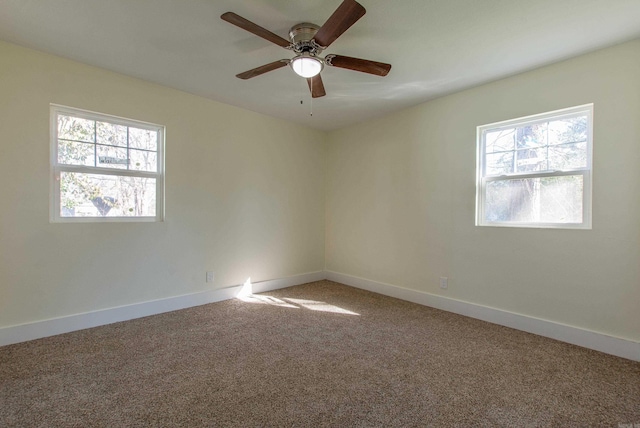 carpeted empty room with ceiling fan and a healthy amount of sunlight