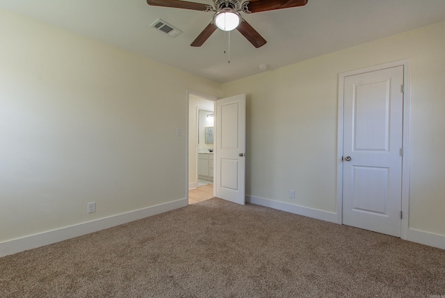 unfurnished bedroom with ceiling fan and light colored carpet