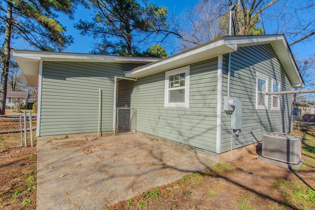 view of side of home featuring central AC unit