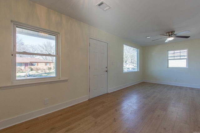 spare room featuring hardwood / wood-style floors and ceiling fan