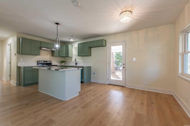 kitchen with stainless steel electric stove, pendant lighting, a center island, light hardwood / wood-style floors, and green cabinets