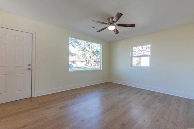 unfurnished room featuring ceiling fan, plenty of natural light, and light wood-type flooring