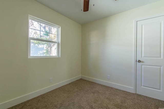 carpeted empty room featuring ceiling fan