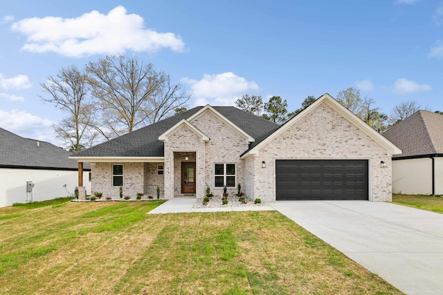 view of front of house with a front yard and a garage