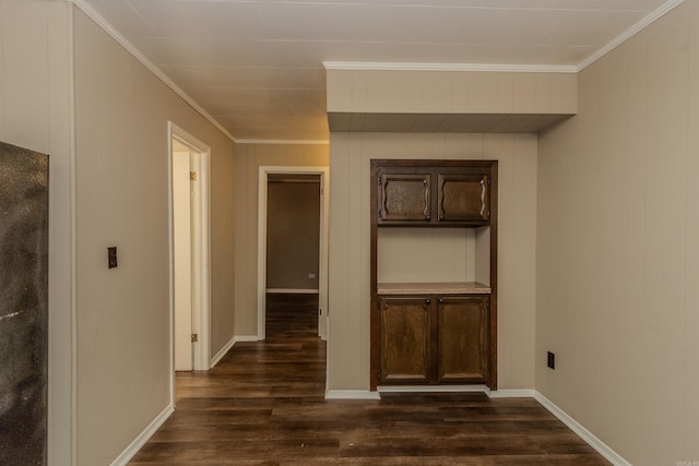 corridor with dark hardwood / wood-style floors and ornamental molding