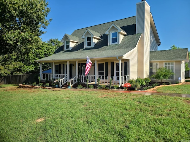 new england style home featuring covered porch and a front yard