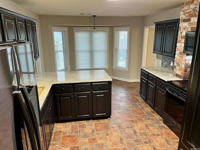 kitchen featuring tasteful backsplash, plenty of natural light, decorative light fixtures, and black range with electric cooktop