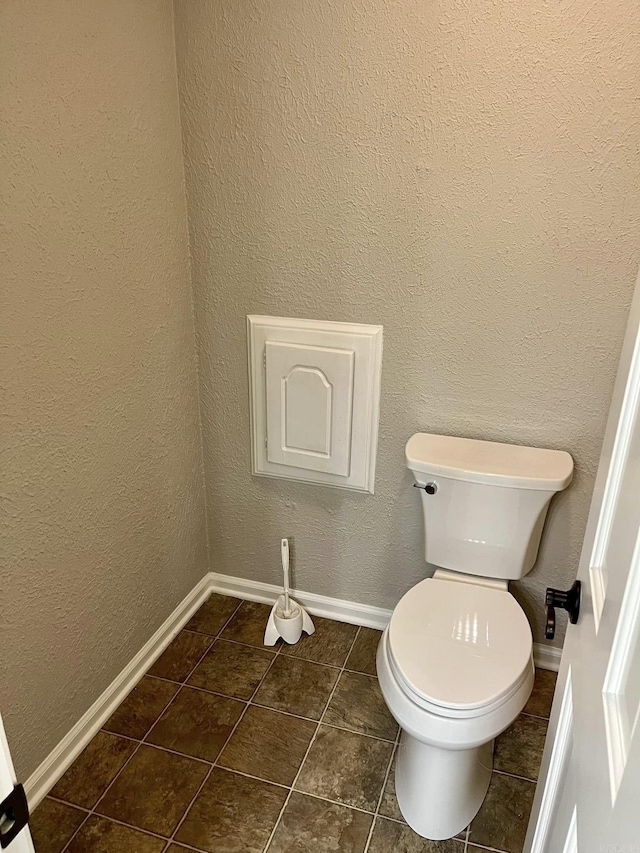 bathroom with tile patterned flooring and toilet