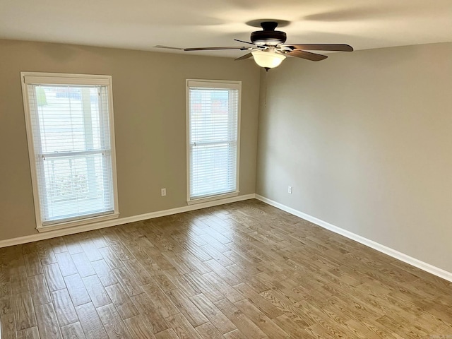 spare room with light wood-type flooring and ceiling fan