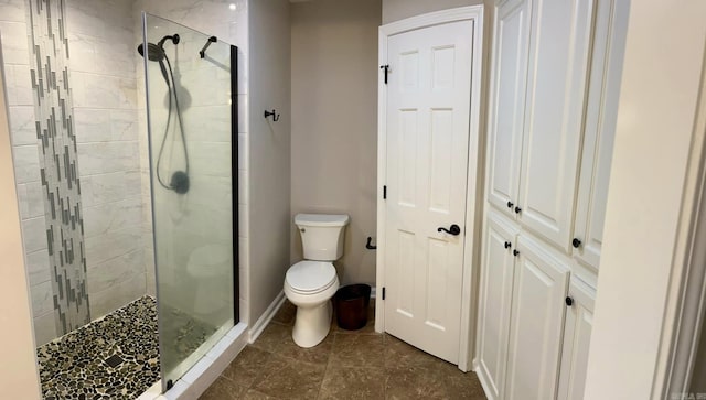 bathroom with toilet and an enclosed shower