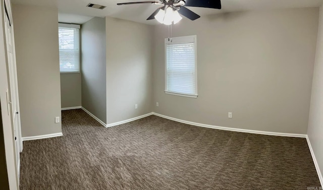 carpeted spare room with ceiling fan