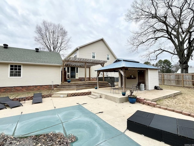 rear view of house featuring a pergola, a patio area, and a deck