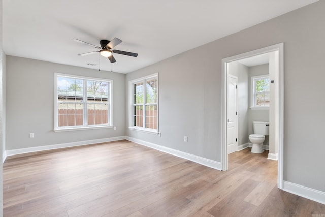 unfurnished room with ceiling fan, plenty of natural light, and light wood-type flooring