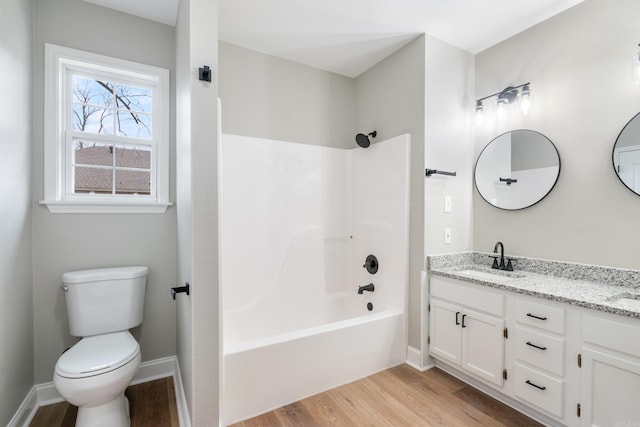 full bathroom featuring bathtub / shower combination, vanity, hardwood / wood-style flooring, and toilet