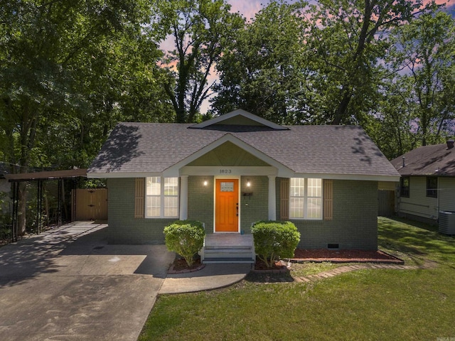 view of front of property with a yard and a carport