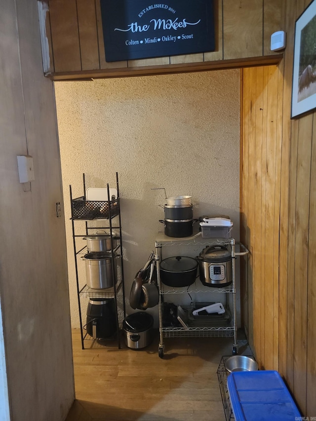 details featuring wood-type flooring and wood walls