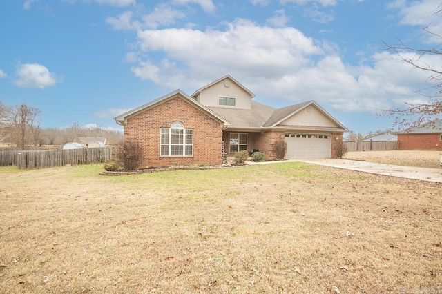 view of front of house featuring a front yard and a garage