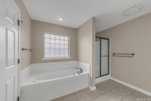 bathroom with tile patterned flooring and separate shower and tub